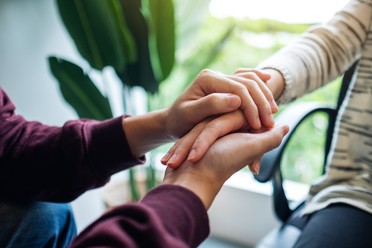 man-woman-holding-each-other-hands-comfort-love